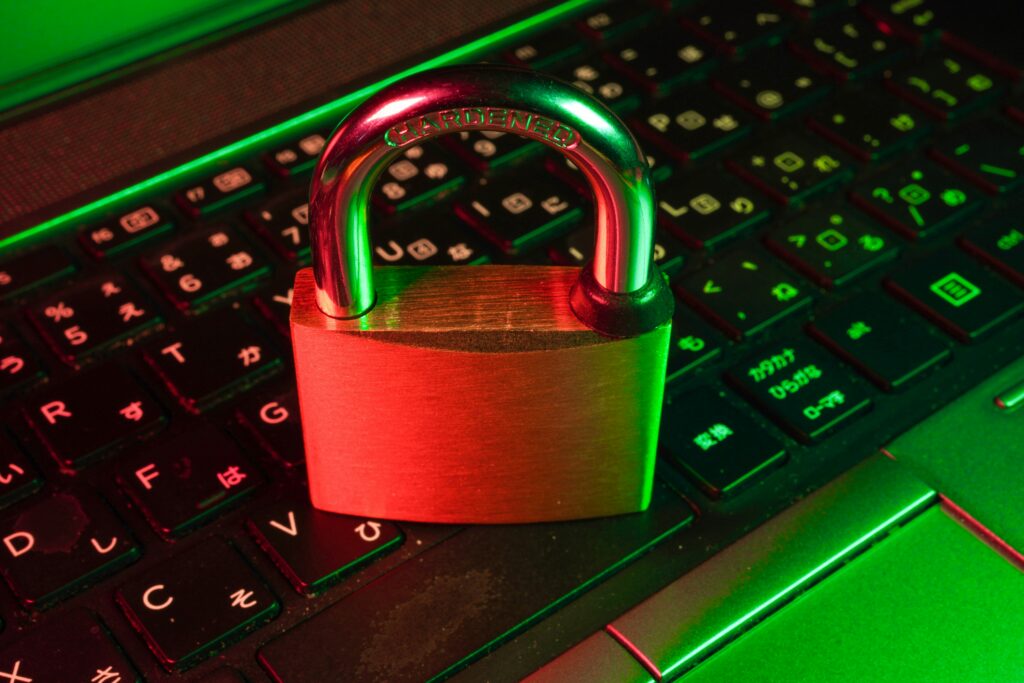 IT Automation visual Padlock on a laptop keyboard lit in red and green, representing secure access controls.