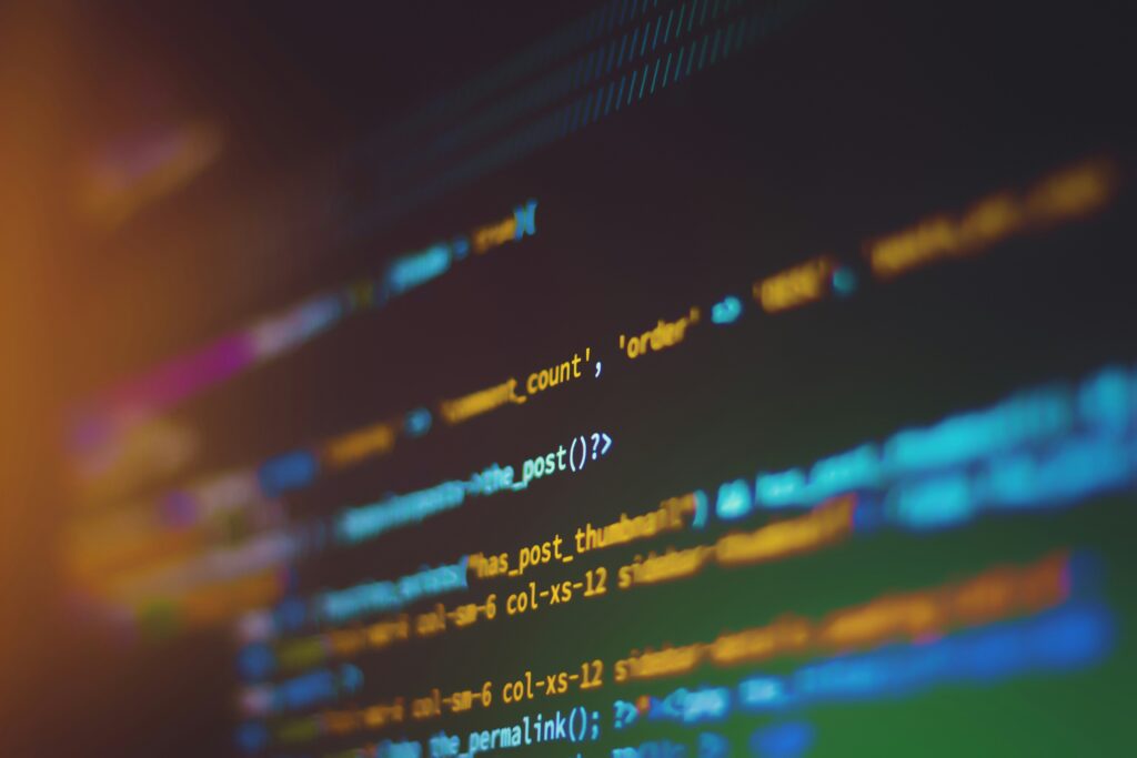 Close-up of code on a screen representing security monitoring tools and detection logic.