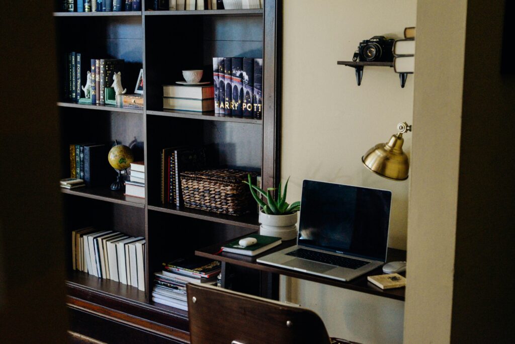 Email retention policy rollout in a business workspace with laptop and office shelving