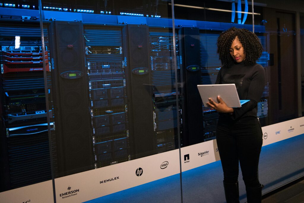 Hybrid Cloud Security monitoring in a server room with an IT engineer
