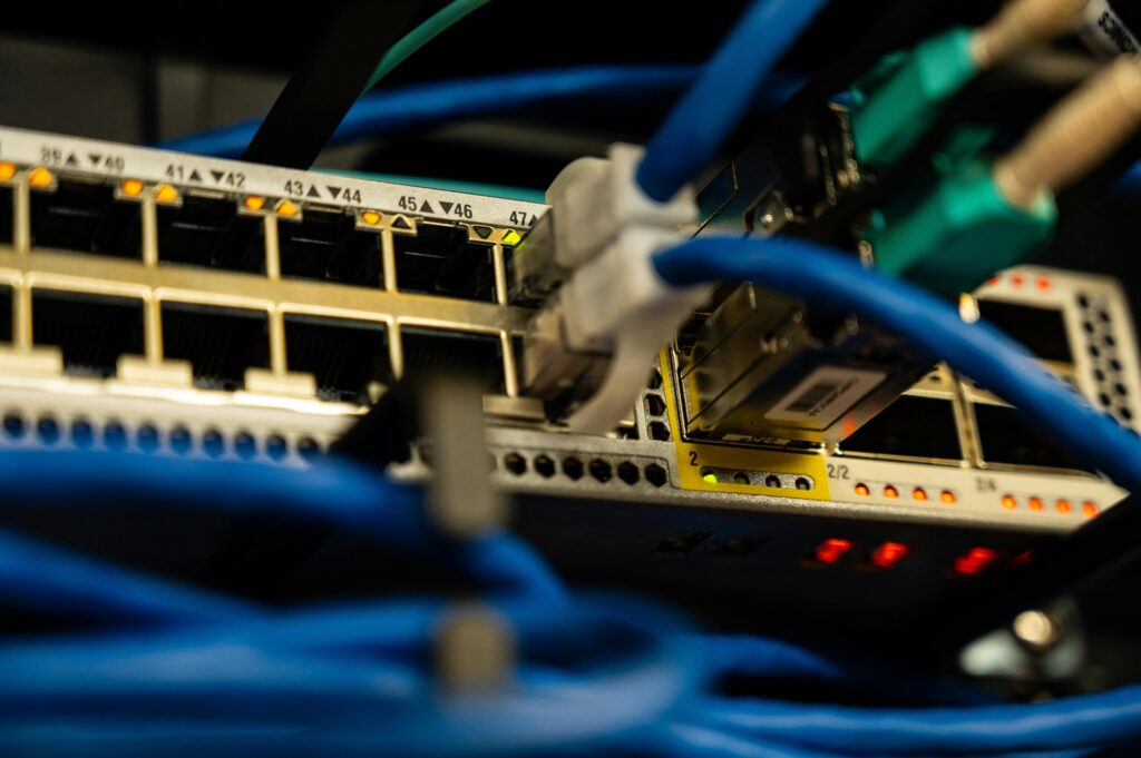 Ethernet cables connected to a network switch in an IT rack.