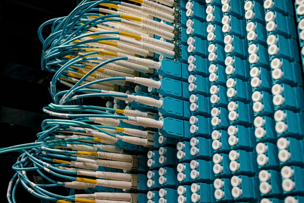 Close-up of fiber patch cables connected to a patch panel in a data center.