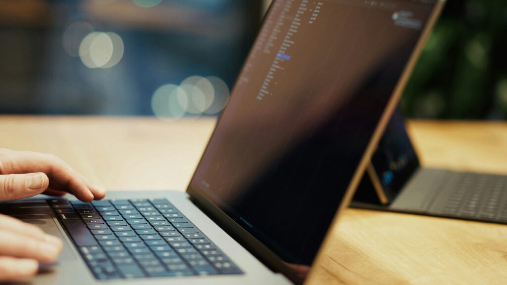 Endpoint Management image showing hands typing on a laptop during device administration