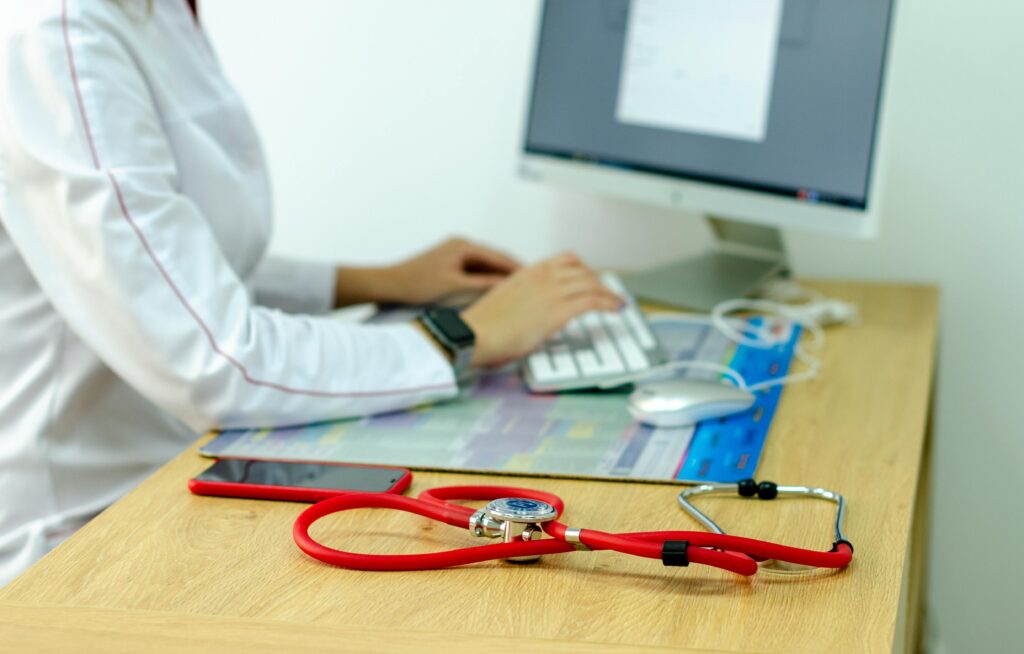Laptop and stethoscope on a desk symbolizing managed IT services for healthcare and secure medical technology
