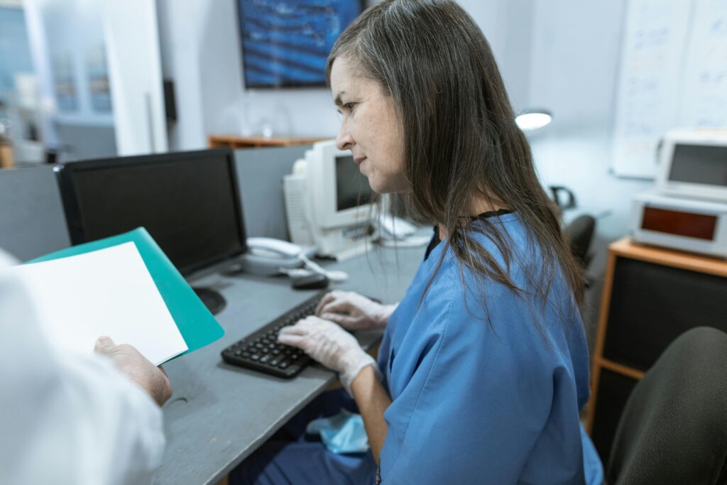 Healthcare worker using a computer at a medical workstation with managed IT services for healthcare support