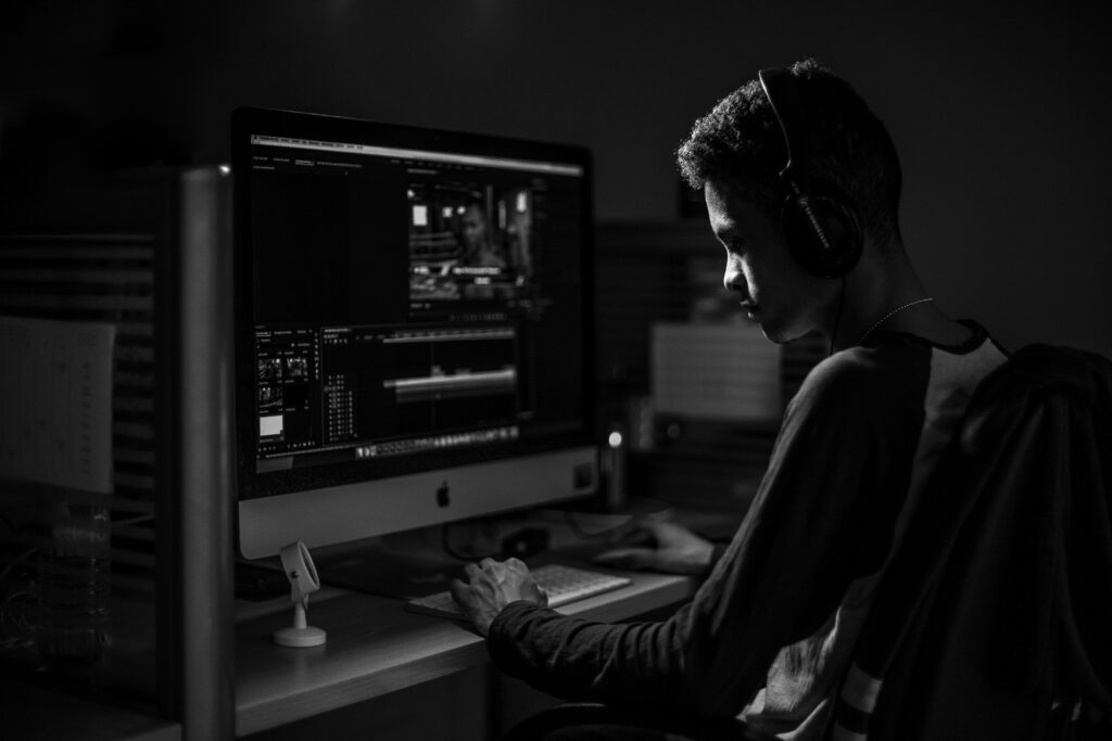 Video editor working at a computer workstation during post-production for a film project