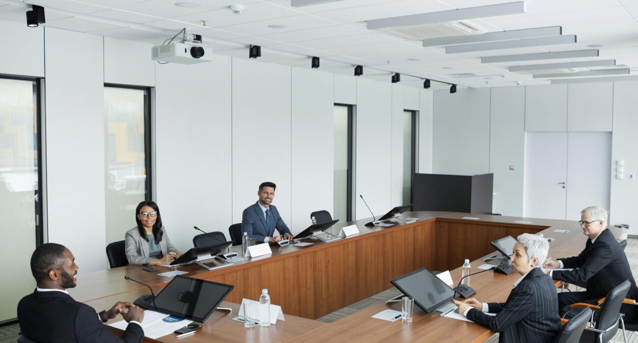 Business professionals meeting in a modern conference room during a compliance risk assessment discussion.