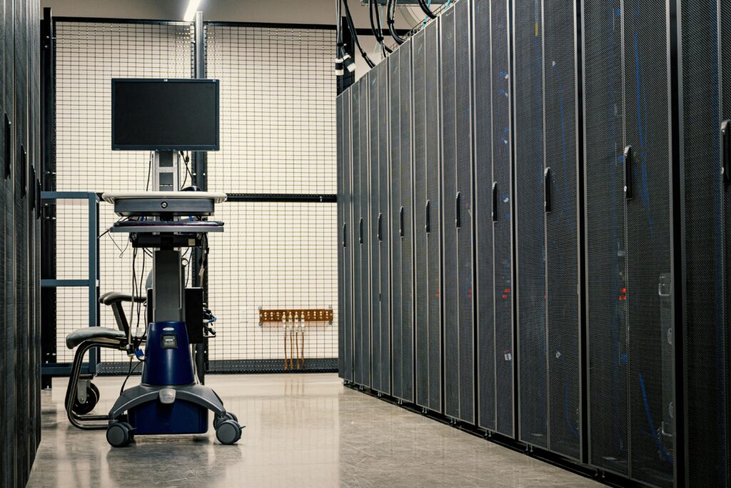 Large enterprise server racks and monitoring station inside a secure data center environment.