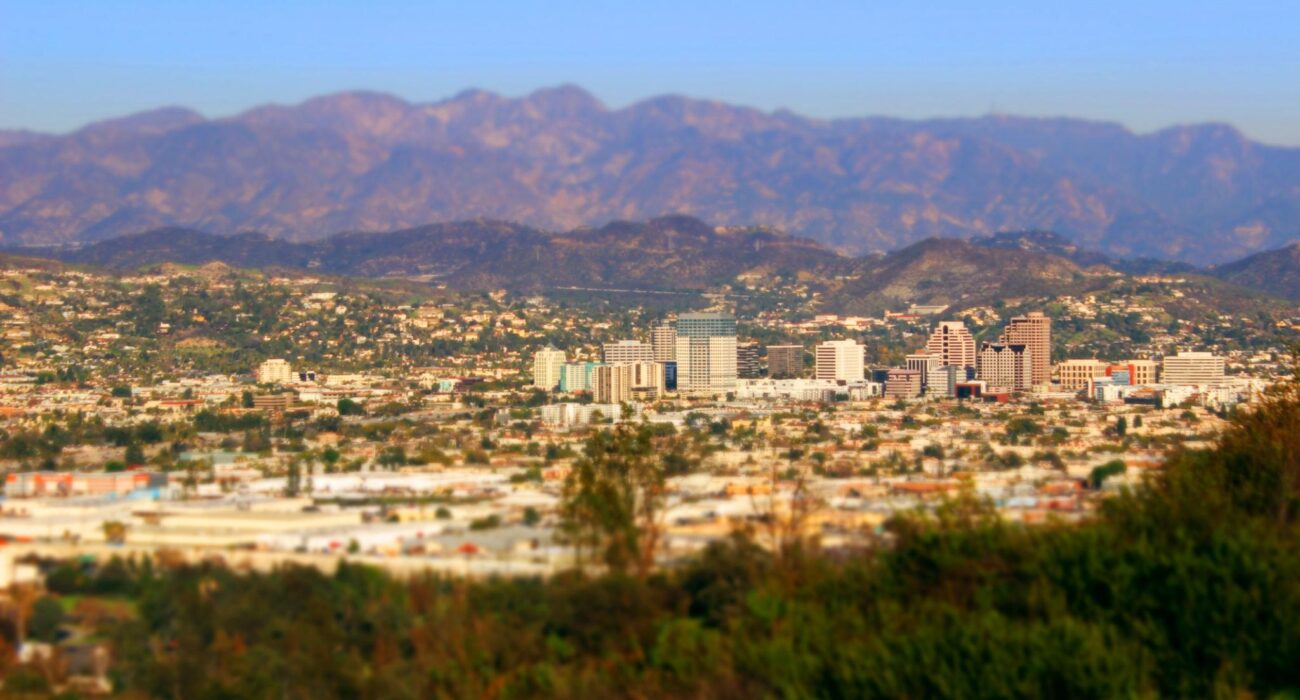 Aerial view of Burbank, CA skyline with mountains in the background