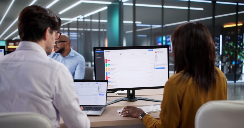 Managed IT services in Sherman Oaks with an IT support team reviewing service tickets on office computers.