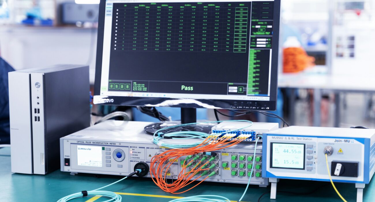 Computer monitor and network testing equipment representing secure infrastructure and system validation for compliance.