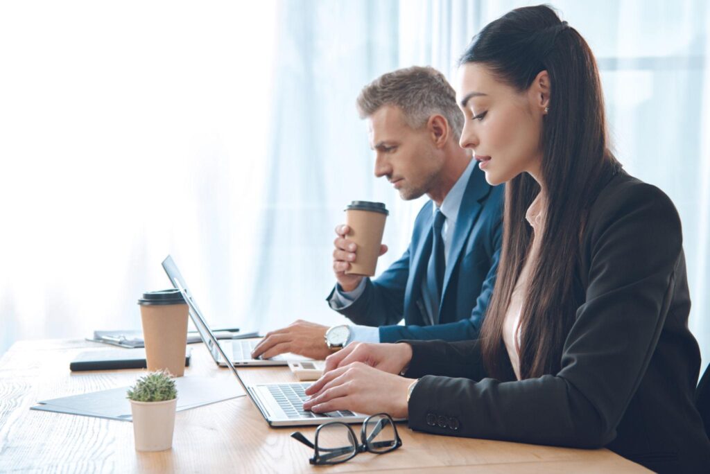 Business professionals using laptops with managed IT services support in Santa Monica CA