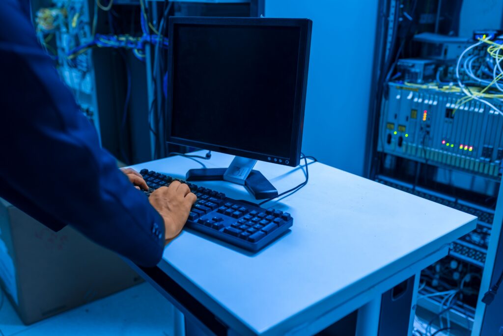 IT technician monitoring servers and network systems for suspicious activity and cybersecurity threats.