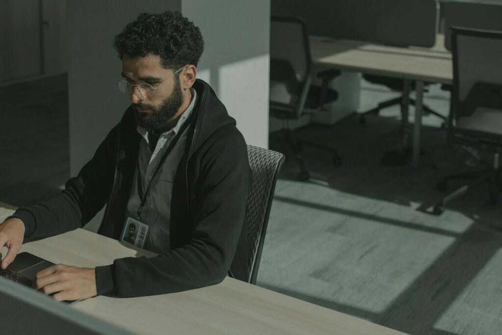 IT professional working on a laptop in an office supporting Microsoft 365 security services in Los Angeles.