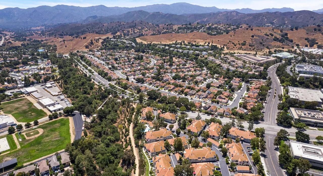 Aerial view of Calabasas neighborhoods, business areas, and surrounding Southern California hills.