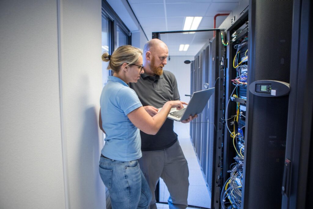 Technicians reviewing server equipment for managed IT services in Pasadena business environments