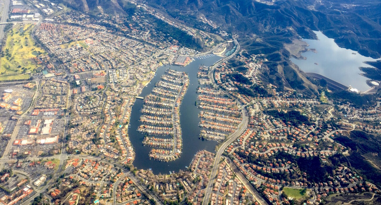 Aerial view of Westlake Lake, surrounding neighborhoods, and mountains near Westlake Village, California